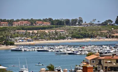 a bunch of boats are docked in a harbor at 313 E Bay Ave B in Newport Beach