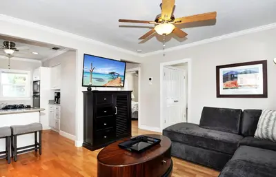 a living room with a couch and a ceiling fan at 313 E Bay Ave B in Newport Beach
