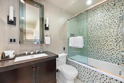 a bathroom with a toilet and a glass shower at Villa Da Vinci at the Retreat at Laguna Beach in Laguna Beach