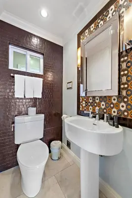 a bathroom with a white toilet and a sink at Villa Da Vinci at the Retreat at Laguna Beach in Laguna Beach