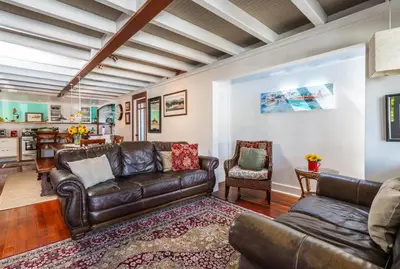 a living room with a leather couch and chairs at 318 Lindo Ave in Newport Beach