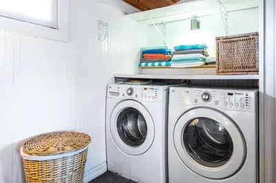 a laundry room with a washing machine and a basket at 318 Lindo Ave in Newport Beach