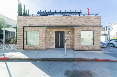a brick building with a parking meter in front of it at 501 E Bay Ave in Newport Beach