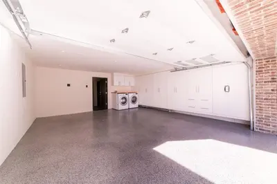 an empty room with two washing machines and a brick wall at 501 E Bay Ave in Newport Beach