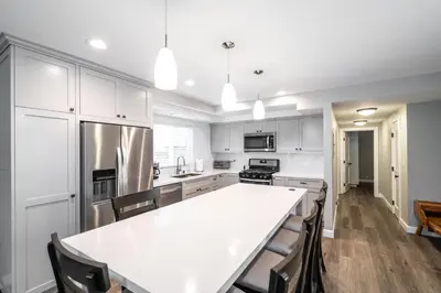 a kitchen with white cabinets and a white counter top at 129 Opal Ave A in Newport Beach