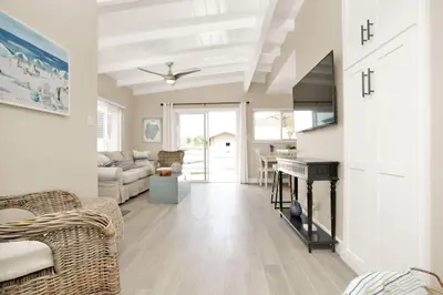 a living room with a fireplace and a piano at 114 Forty Second Street B in Newport Beach
