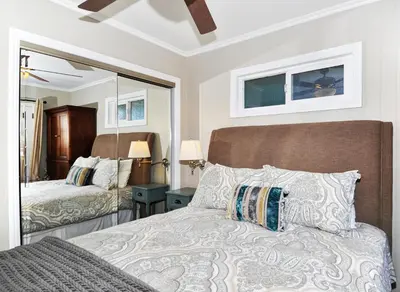 a bedroom with a bed and a large mirror at 313 E Bay Ave A & B in Newport Beach