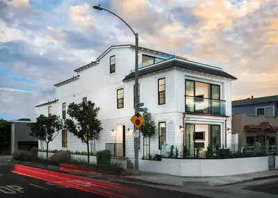 a white building on the corner of a street at Upper West Newport in Newport Beach