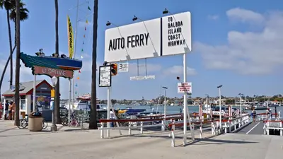 a sign for a marina with boats in the water at Upper West Newport in Newport Beach