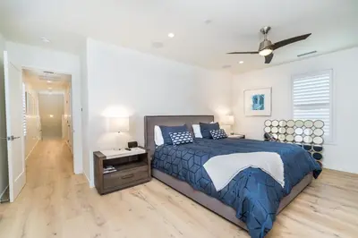 a bedroom with a bed and a ceiling fan at Upper West Newport in Newport Beach