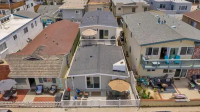 an aerial view of a house with chairs and umbrellas at 114 Forty Second Street A and B in Newport Beach