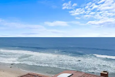 a view of the ocean with surfers in the water at Villa Leone at the Retreat in Laguna Beach in Laguna Beach