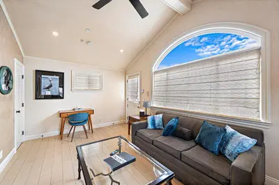 a living room with a couch and a large window at Villa Teatro at the Retreat in Laguna Beach in Laguna Beach