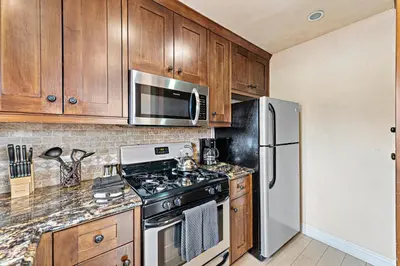 a kitchen with a stove and a refrigerator at Villa Teatro at the Retreat in Laguna Beach in Laguna Beach