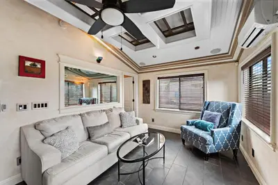 a living room with a couch and two chairs at Villa Palazzo D'Stella at the Retreat in Laguna Beach