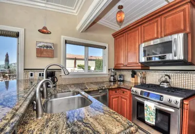 a kitchen with a sink and a stove at Villa Roma at the Retreat in Laguna Beach in Laguna Beach