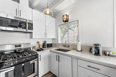 a white kitchen with a stove and a sink at Sleepy Hollow Villas #2 in Laguna Beach in Laguna Beach