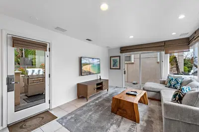 a living room with a couch and a table at Villa Lanai at the Sunset Cove Villas in Laguna Beach