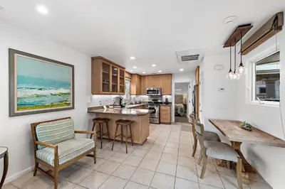 a kitchen and dining room with a table and chairs at Villa Lanai at the Sunset Cove Villas in Laguna Beach
