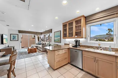 a kitchen and living room with a couch at Villa Lanai at the Sunset Cove Villas in Laguna Beach