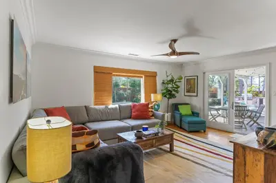 a living room with a couch and a table at Luxury Beach House. Pool/Hot Tub! Walk to Beach! in Carlsbad
