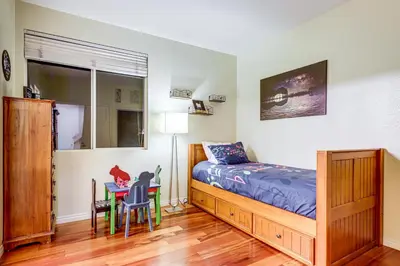 a bedroom with a bed and a desk and a table at 1 Mi to the Beach! Ocean-View Encinitas Home in Encinitas
