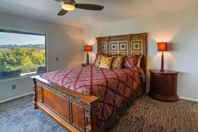 a bedroom with a bed and a large window at Fallbrook Home with Mountain Views Close to Hiking! in Fallbrook