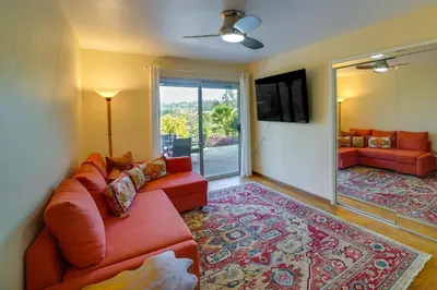 a living room with a couch and a tv at Fallbrook Home with Mountain Views Close to Hiking! in Fallbrook