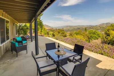 a table and chairs on a patio with a view at Fallbrook Home with Mountain Views Close to Hiking! in Fallbrook