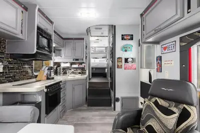 a kitchen and living room of an rv at Harley Davidson Ranch Glampling With Kids Play Zone in Ramona