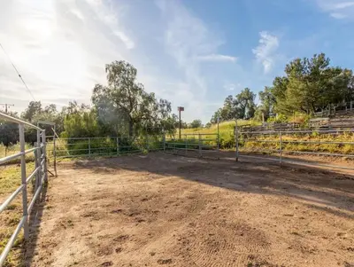 a dirt field with a fence on a farm at Harley Davidson Ranch Glampling With Kids Play Zone in Ramona