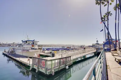 a boat is docked at a dock in the water at Newport Beach Vacation Rental Near Beach and Pier in Newport Beach