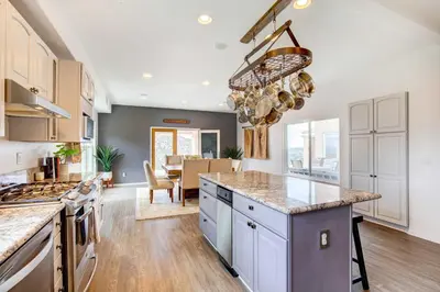 a kitchen with white cabinets and a large counter top at Mountaintop Ramona Home Private Pool, Near Lake! in Ramona