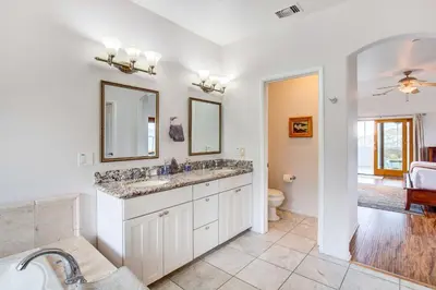 a bathroom with a sink and a toilet and a mirror at Mountaintop Ramona Home Private Pool, Near Lake! in Ramona