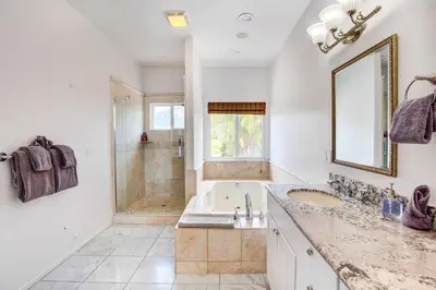 a bathroom with a tub and a sink and a shower at Mountaintop Ramona Home Private Pool, Near Lake! in Ramona